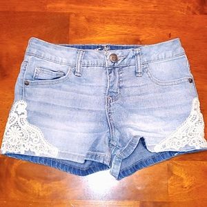 Light wash denim shorts with lacey detailed sides